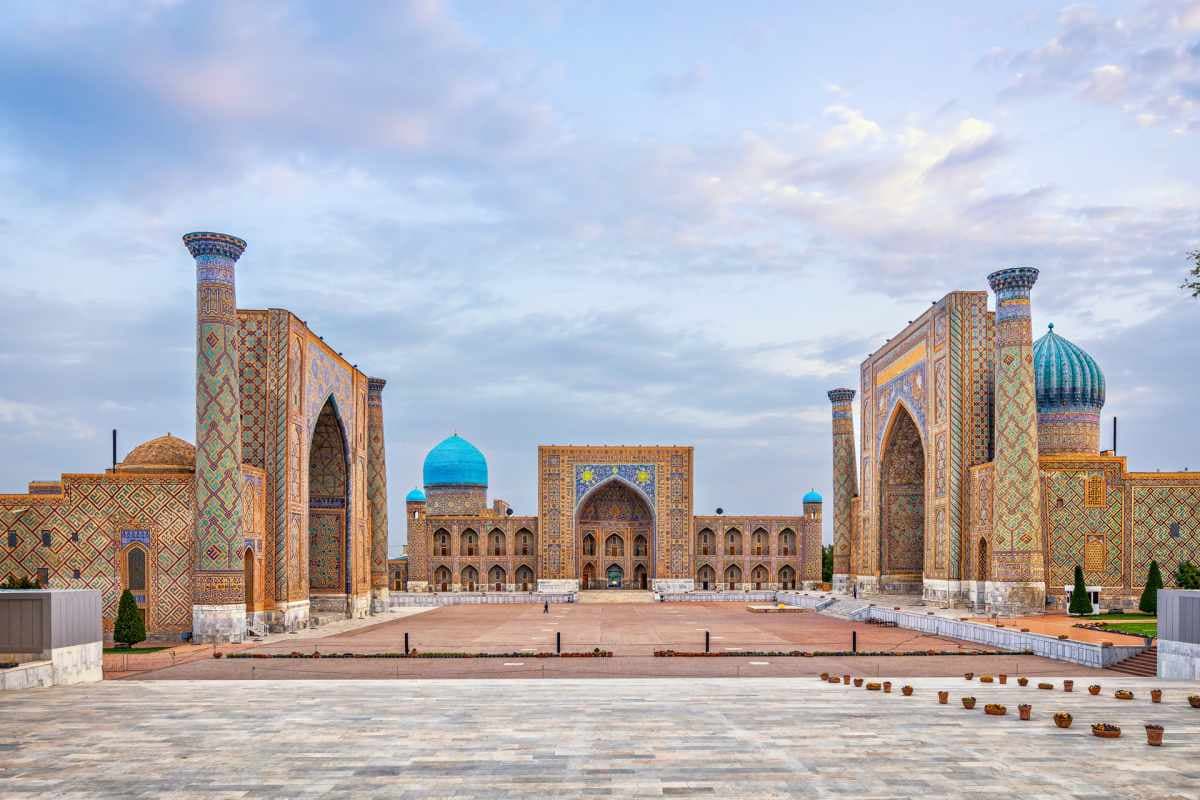 Wide view of Registan Square in Samarkand and its madrasahs on a sunny day